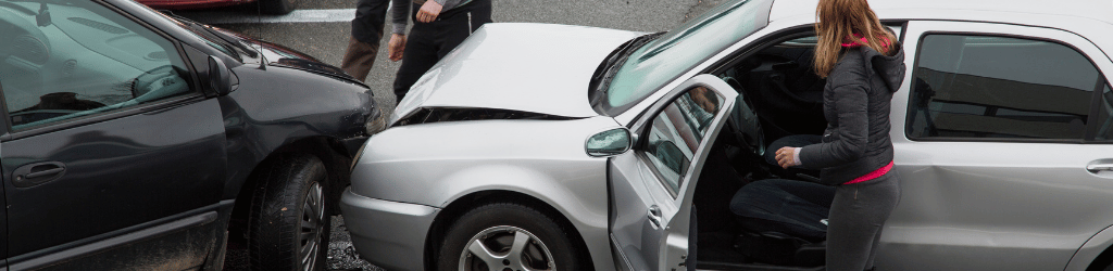 Woman stepping out of car after accident