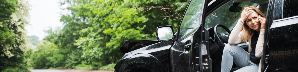 Woman making phone call after car accident