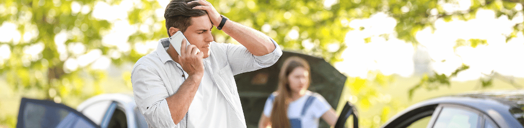 Man on the phone after a head on collision 