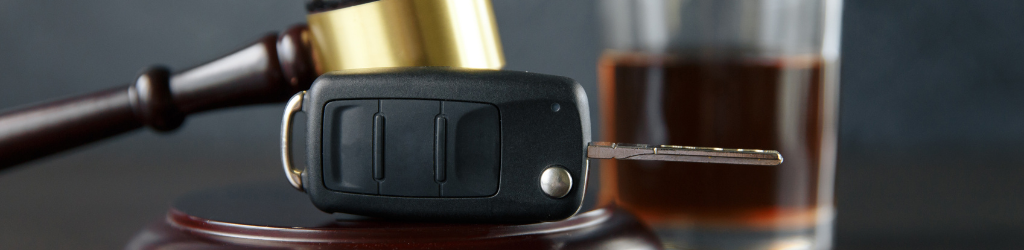 Lawyers desk; gavel, glass of bourbon, car key