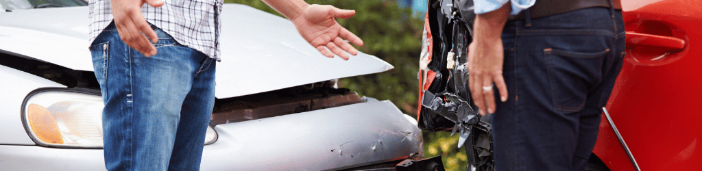 Two men arguing outside a car accident