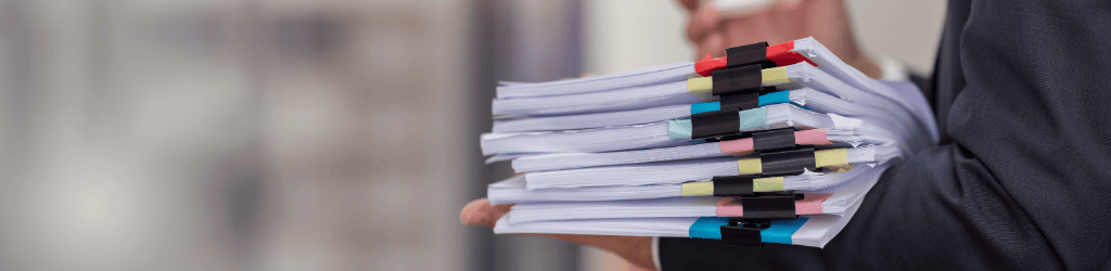 Lawyer with a stack of paperwork and coffee