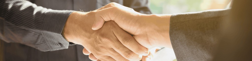 Lawyer shaking hand with client.